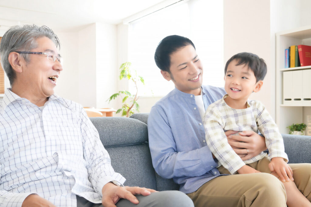 ソファーに座るおじいちゃんとお父さんと男の子